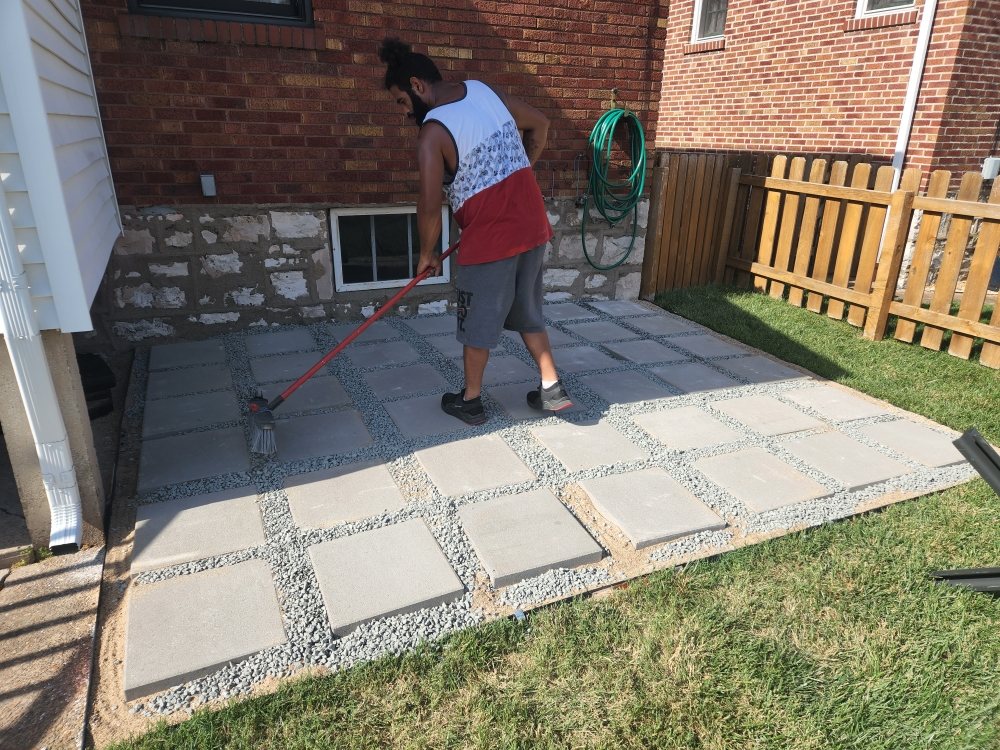 Modern paver patio with gravel joints installed in a backyard