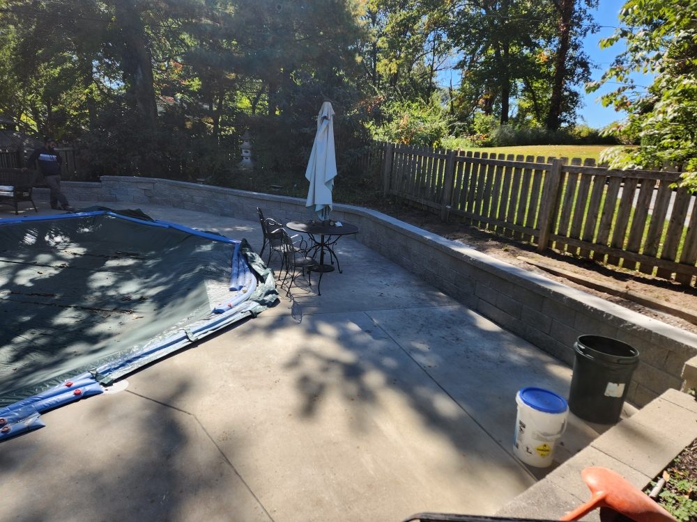 Completed low retaining wall along a concrete patio